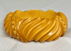 BB378 butterscotch wave and circle carved bakelite bangle